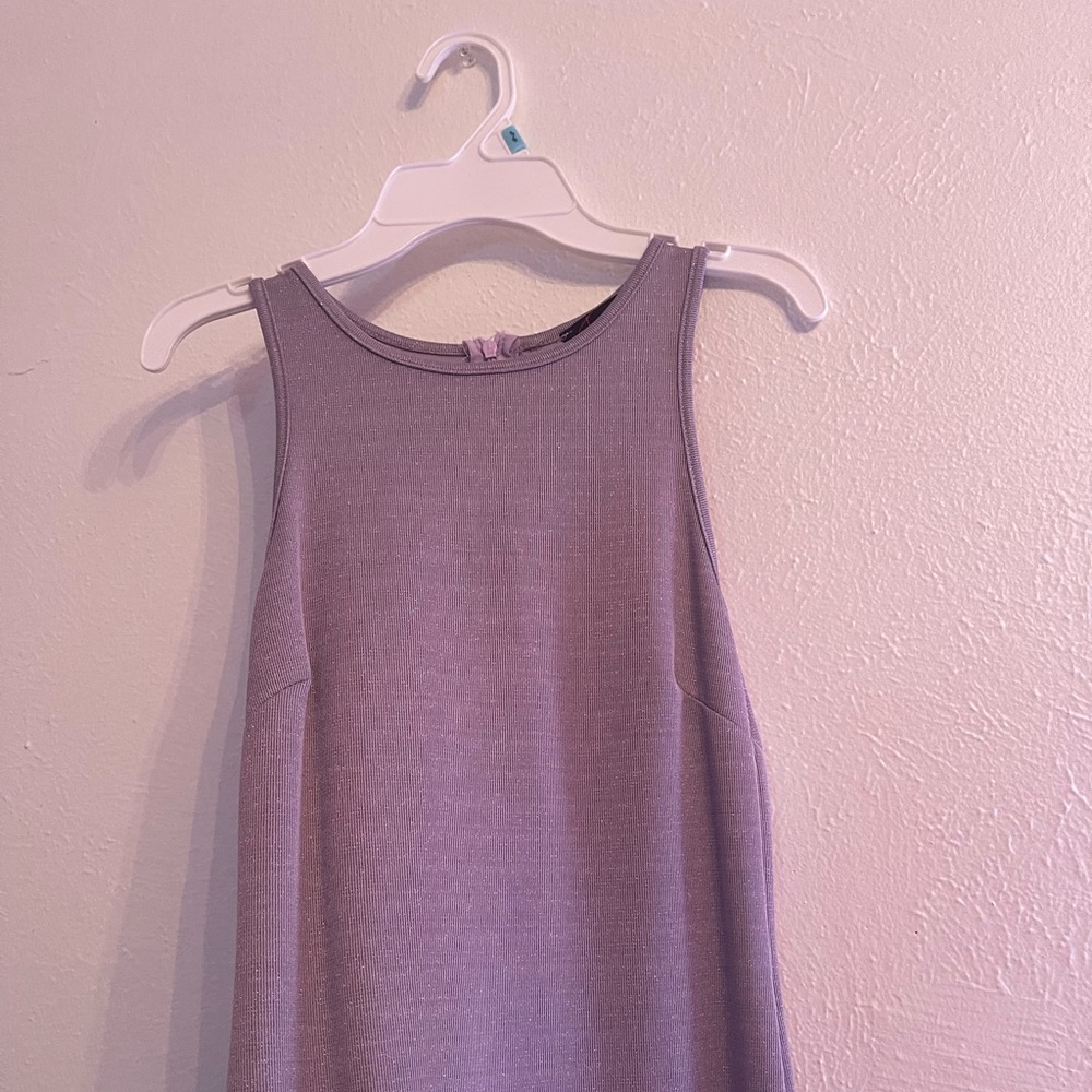 Small, shimmery, purple sleeveless dress with slit